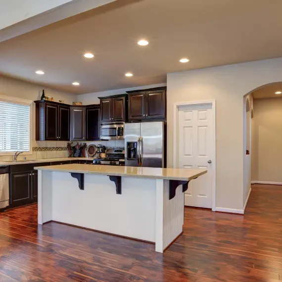 A kitchen with a large island and stainless steel appliances