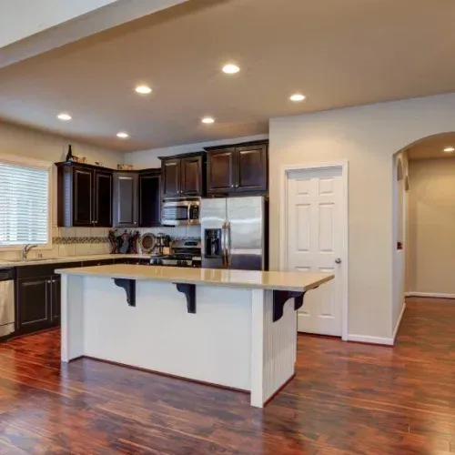 A kitchen with a large island and stainless steel appliances