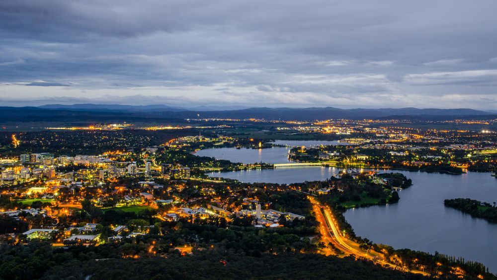 An Aerial View Of A City At Night With A Lake In The Middle — Landschape In Canberra, ACT
