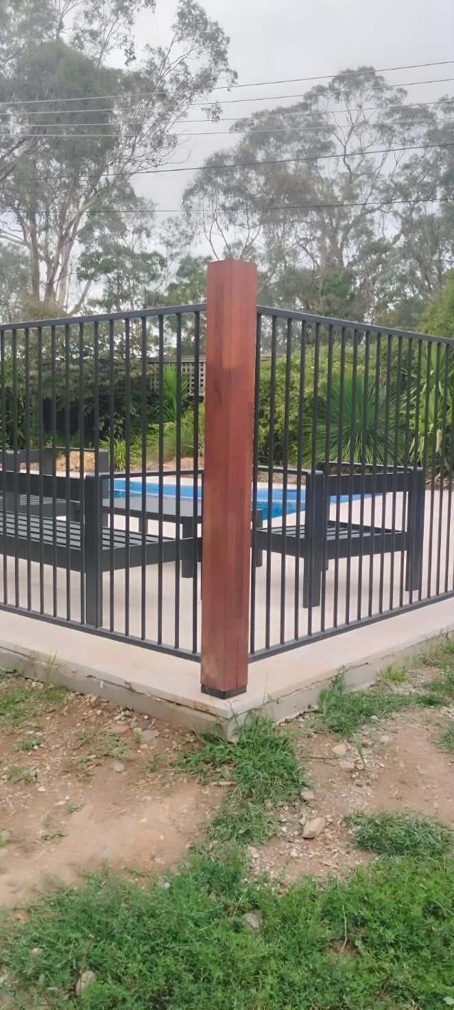 A Fence Around A Swimming Pool With A Wooden Post In The Middle — Landschape In Braddon, ACT