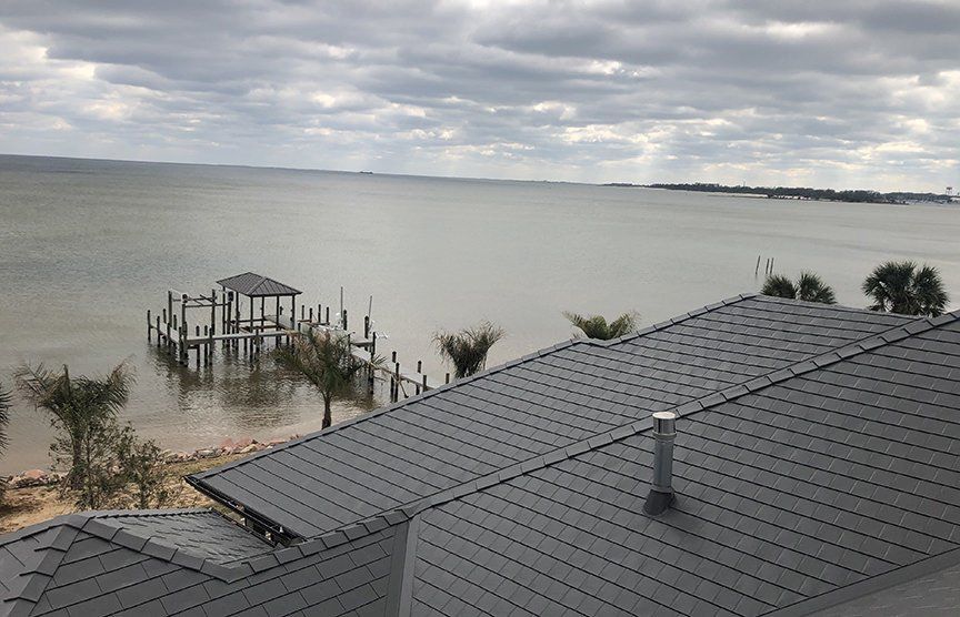 Pensacola FL Musket Grey Interlock Slate Metal Roofing System installed on home on the Gulf of Mexico
