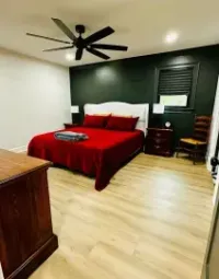 An interior view showing a transition between two different wood floors, with a freshly finished room in the background.