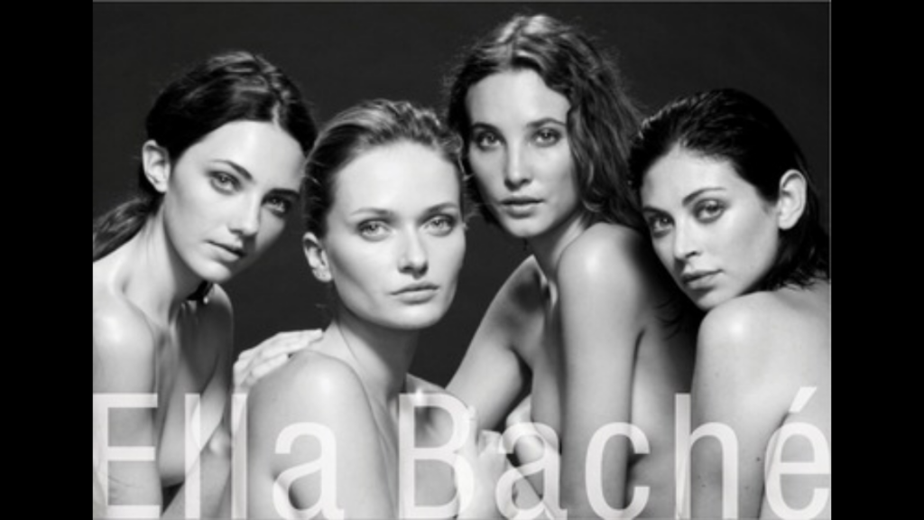 Black and white photo of four bare-shouldered women.