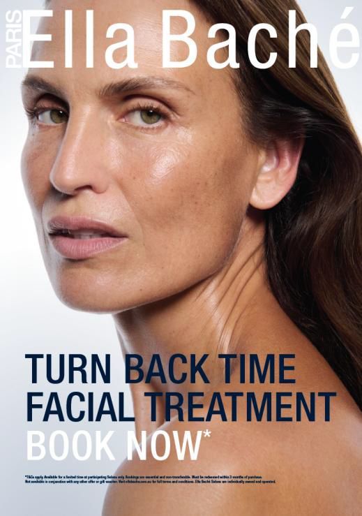 Woman receiving head massage, eyes closed, on a white towel.