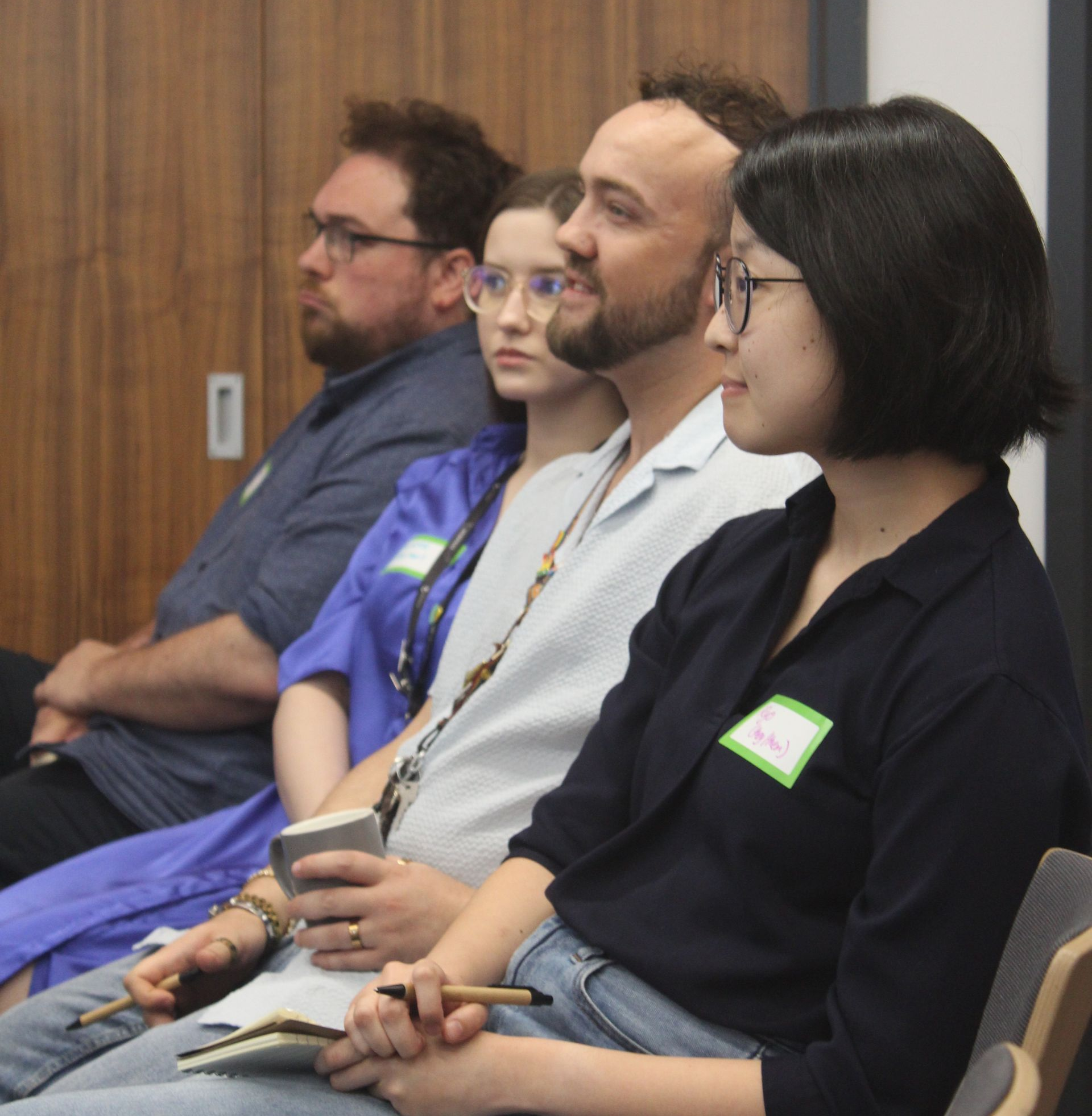 Hands cupped, holding colorful clay letters spelling