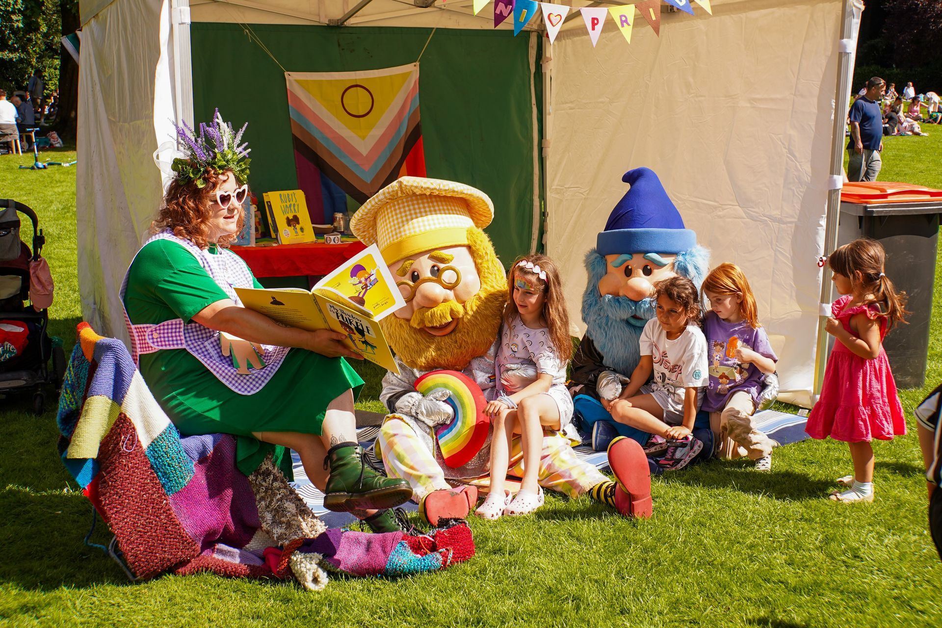 A woman is reading a book to a group of children.