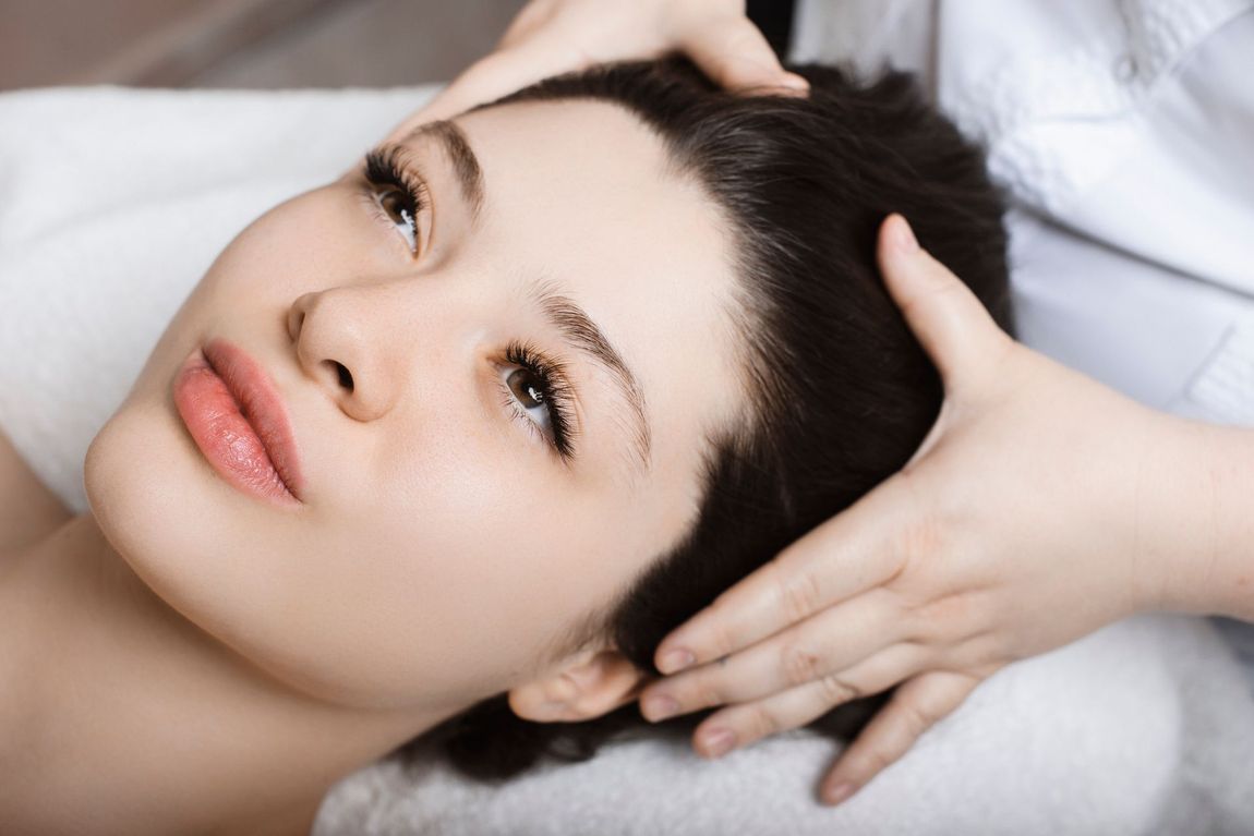 a woman is getting a facial massage at a spa .