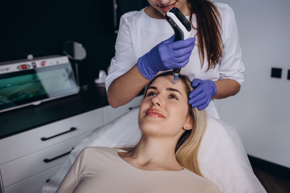 A woman is getting a facial treatment at a beauty salon.