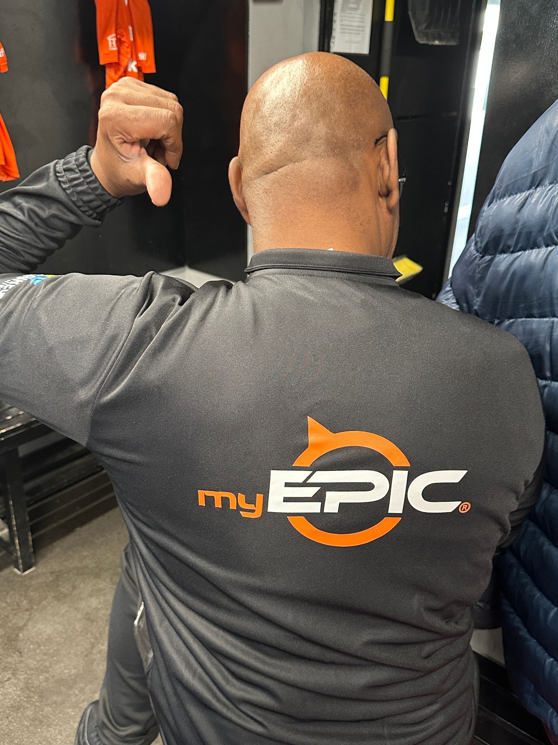 A man is wearing a shirt that says my epic on the back.