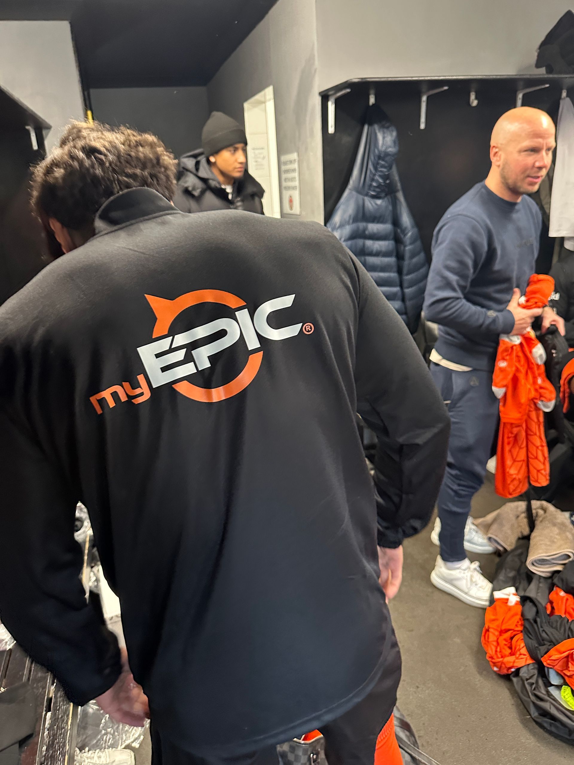 A man wearing a black shirt that says my epic