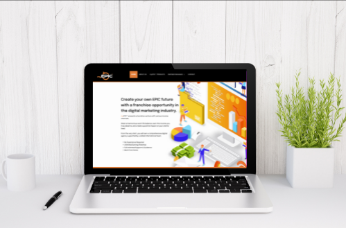 A laptop computer is open to a website on a table.