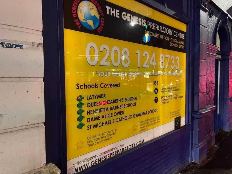 a sign for the genesis preparatory centre on a building