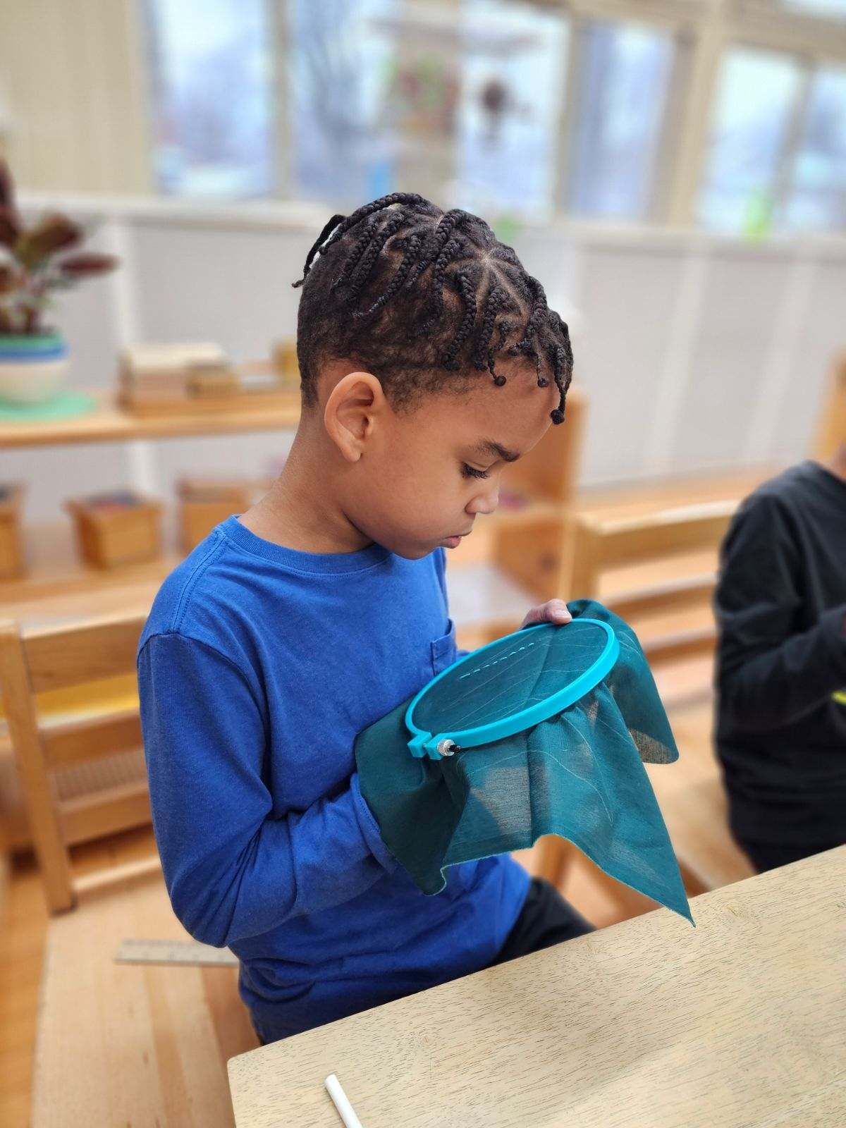 montessori child working with craft activity
