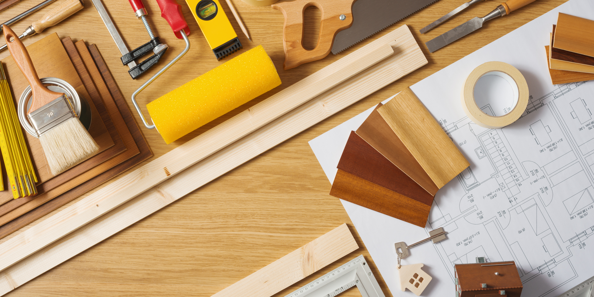 Room under renovation; paint cans, ladder, and supplies strewn about, white walls, natural light.