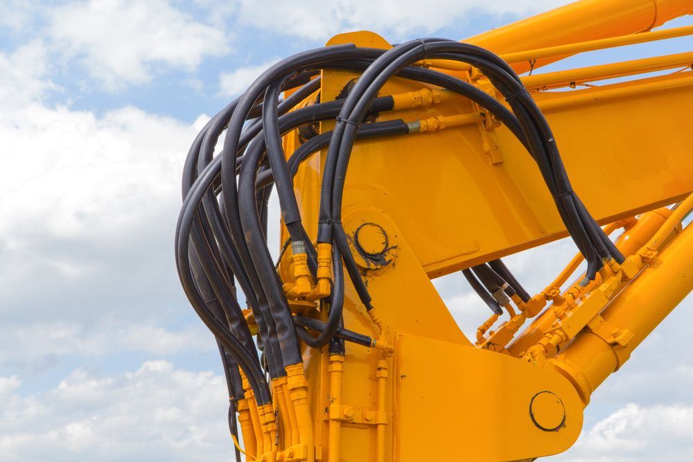 A Close up Of a Yellow Crane with Hydraulic Hoses Attached to It — Alice Hosetech & Industrial Supplies in Ciccone, NT