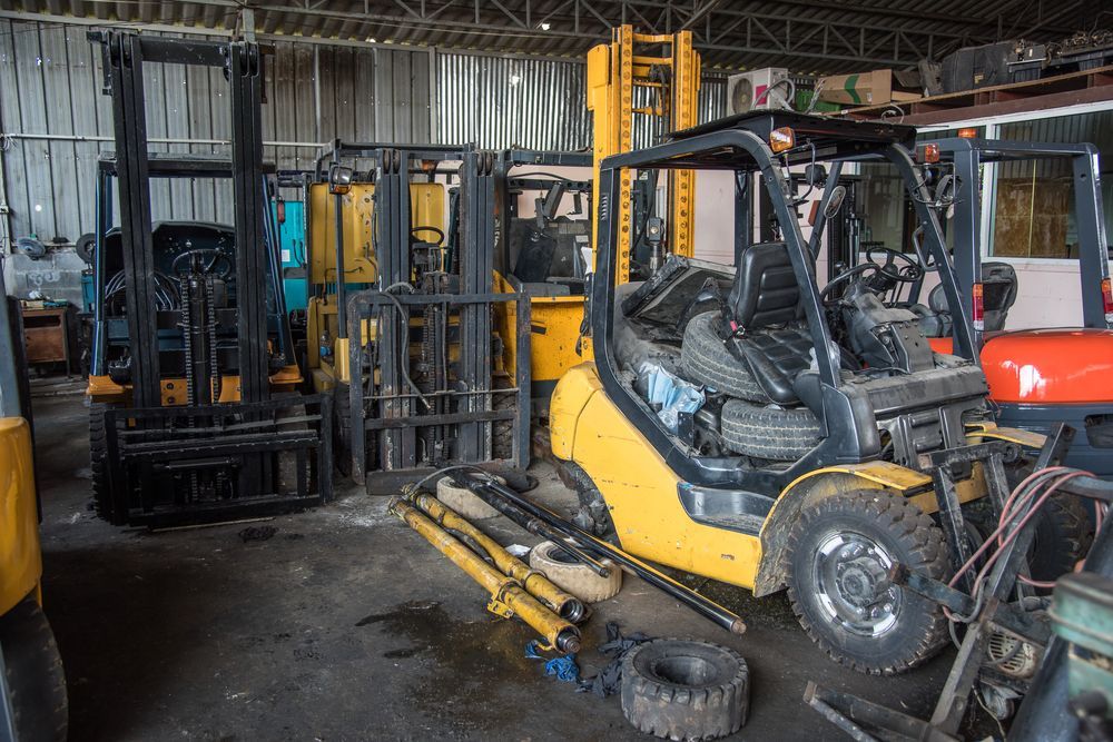 A Row of Forklifts Are Parked in A Warehouse — Alice Hosetech & Industrial Supplies in Ciccone, NT
