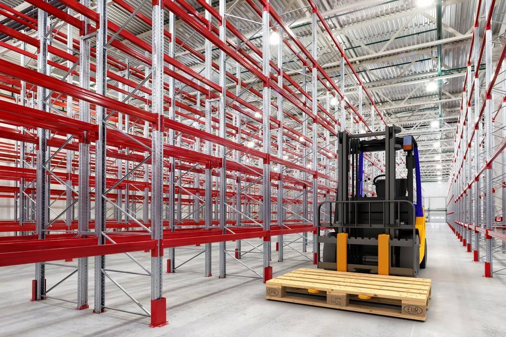 A Forklift Is Moving a Wooden Pallet in A Large Warehouse — Alice Hosetech & Industrial Supplies in Ciccone, NT
