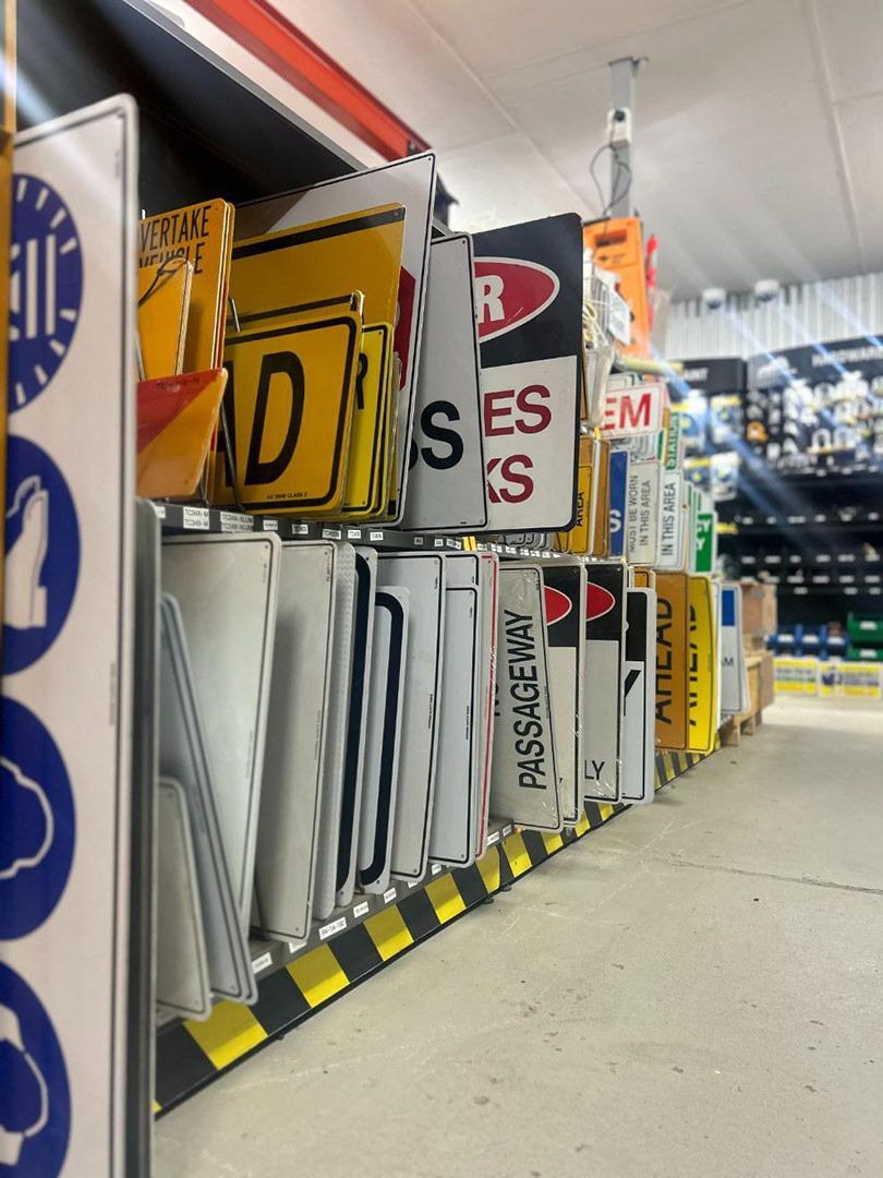 A Bunch of Signs Hanging on A Shelf One of Which Has the Letter D on It — Alice Hosetech & Industrial Supplies in Ciccone, NT