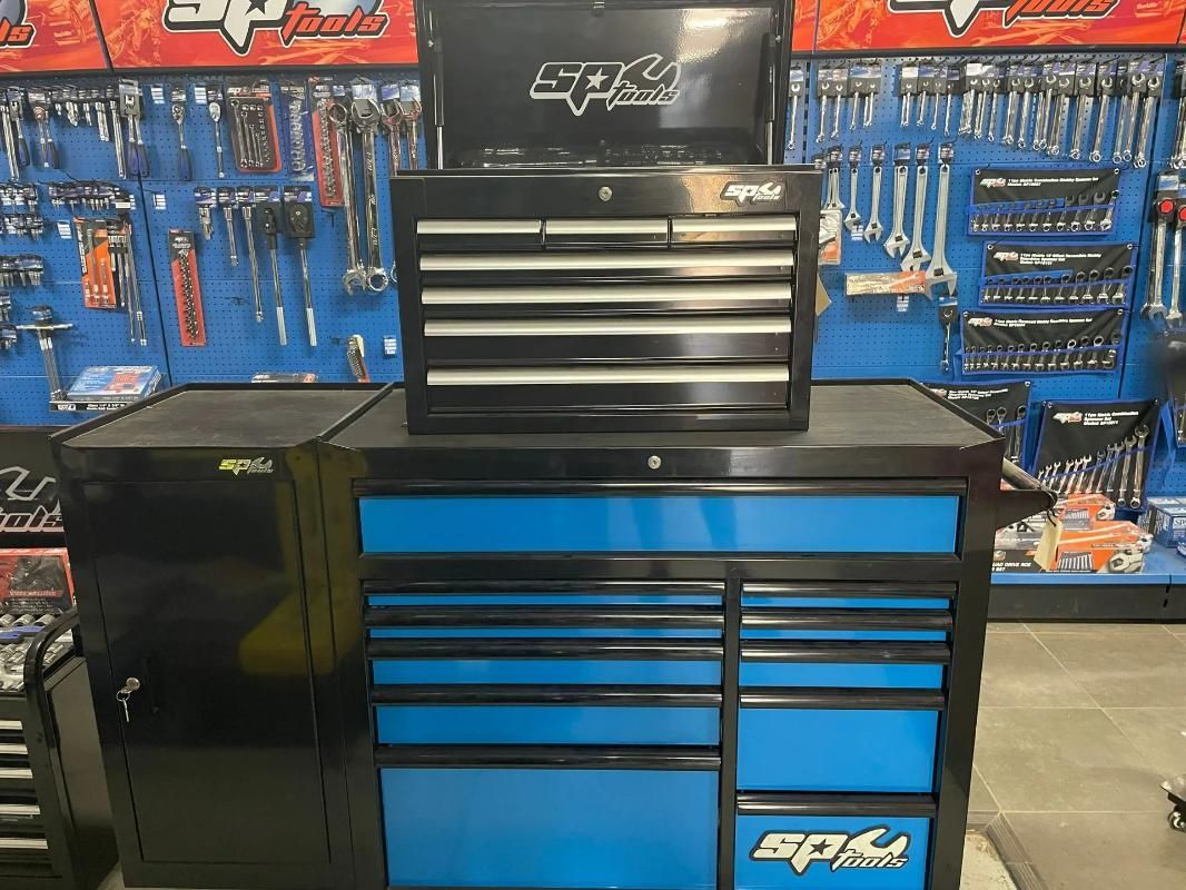 A Black and Blue Toolbox Is Sitting in Front of A Wall of Tools — Alice Hosetech & Industrial Supplies in Ciccone, NT