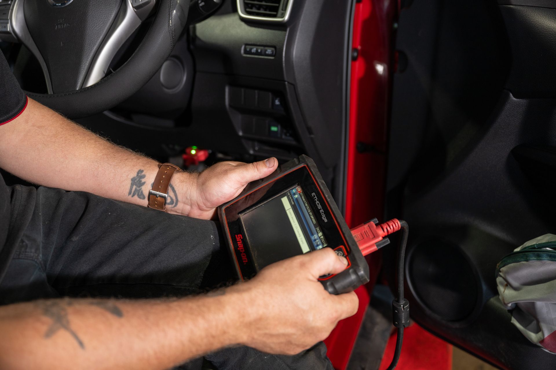 High Angle View Of Mechanic Examining Car Engine — Cherry's Automotive Repairs In Maitland, NSW