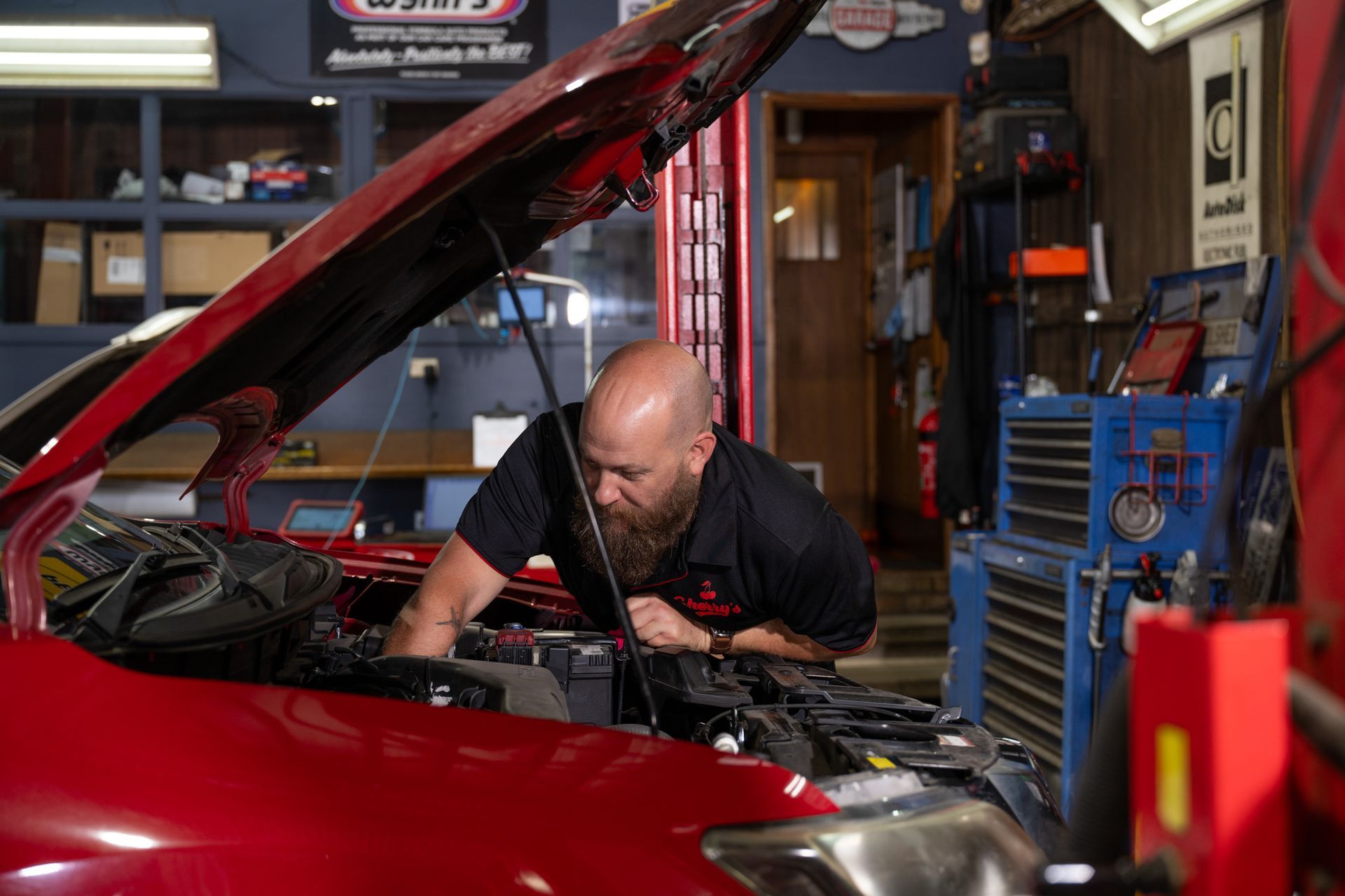 Skilled Mechanic Holding a Service Clipboard and Noting Details — Cherry's Automotive Repairs In Maitland, NSW