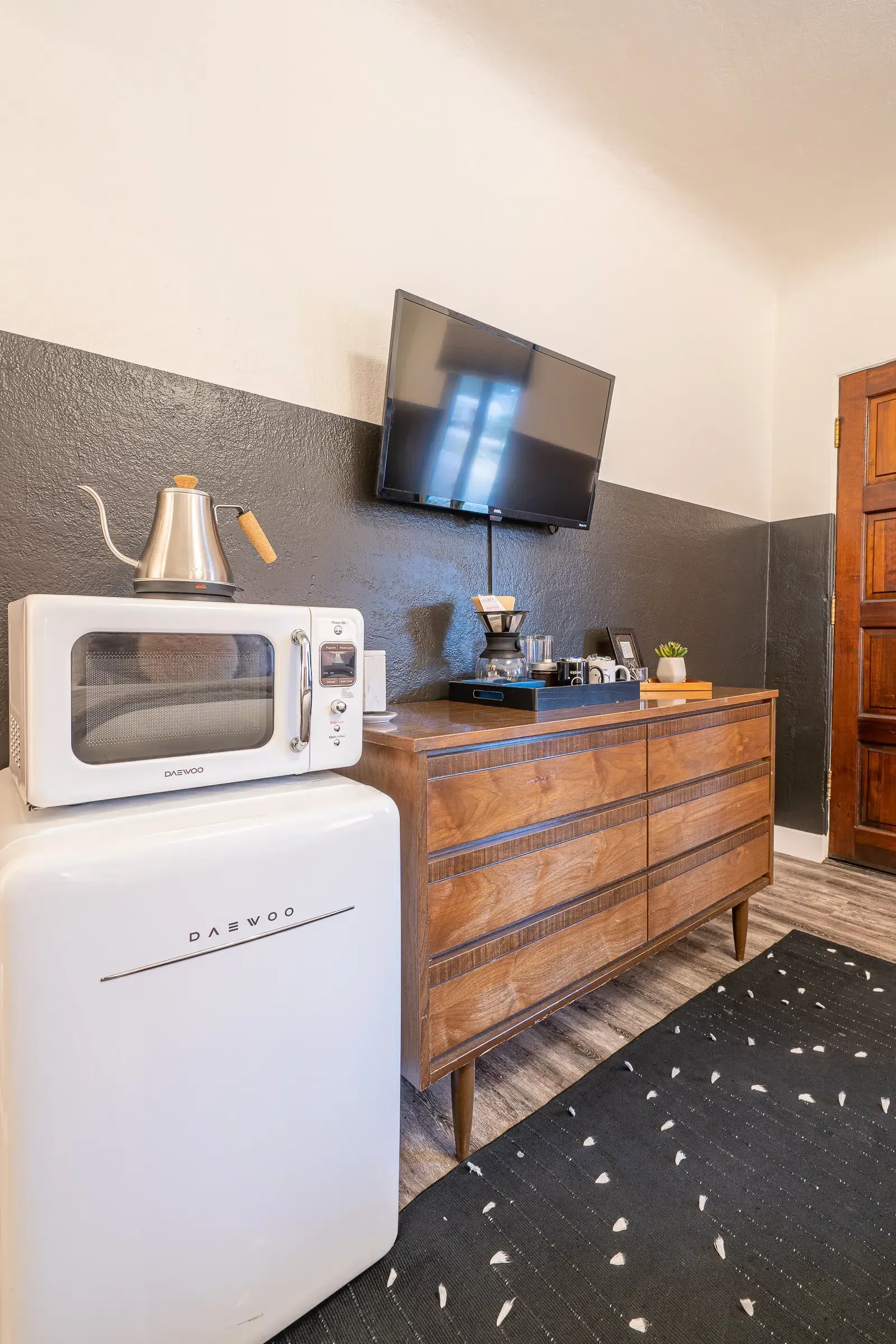 There is a microwave and a refrigerator in the room.