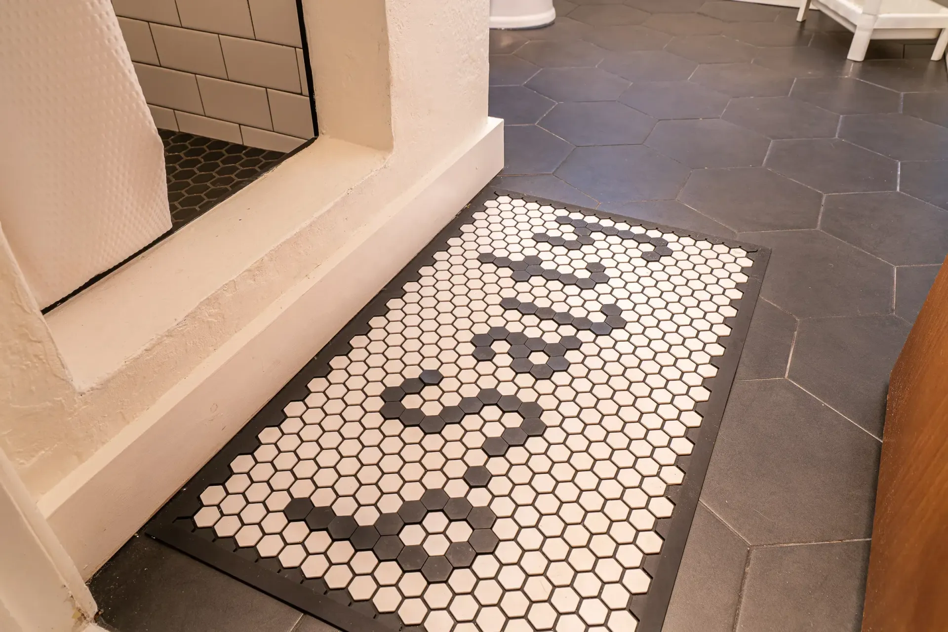 A bathroom with a sink , toilet , shower and mirror.