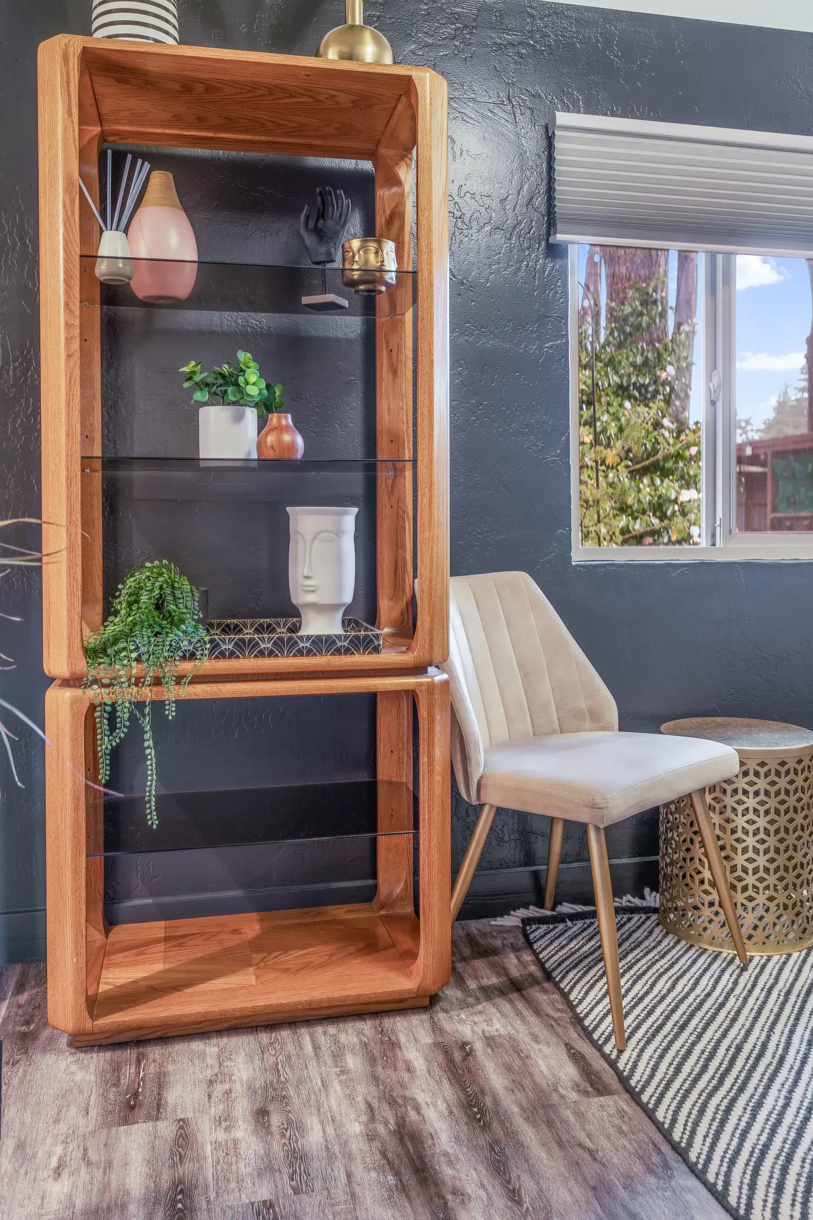 A wooden porch with a bench underneath it.
