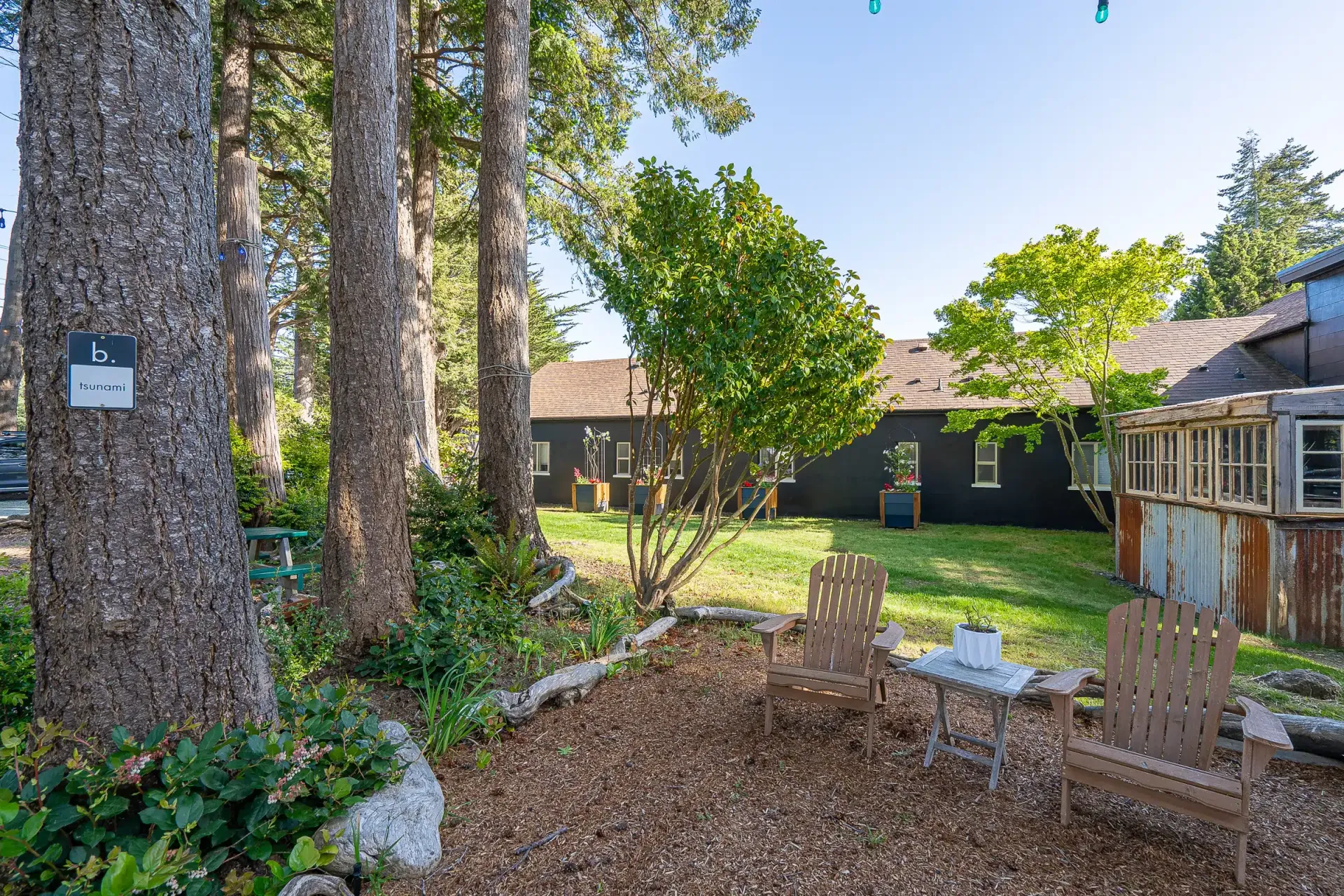 A backyard with a table and chairs in front of a house.