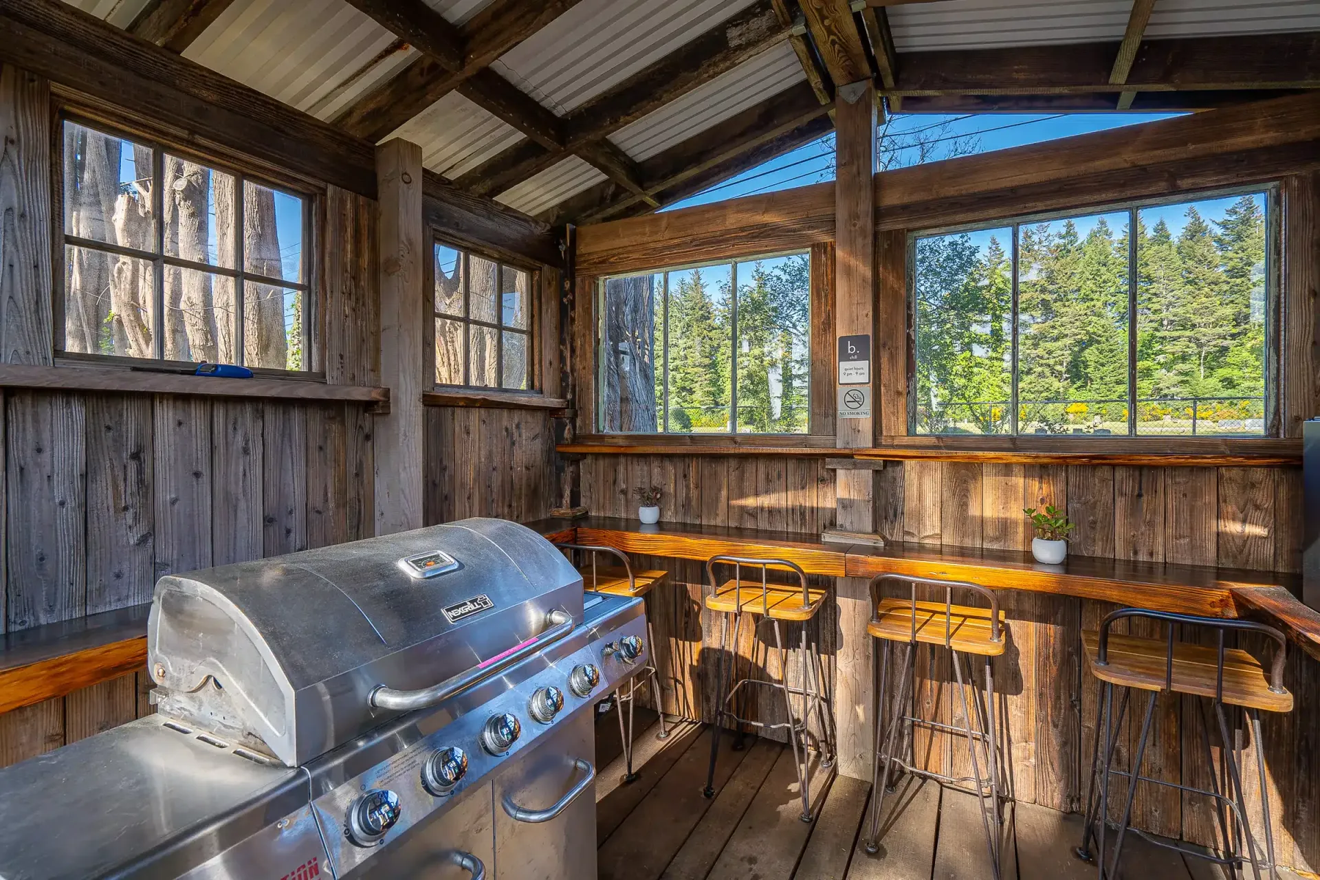 There is a grill in the middle of a wooden building.