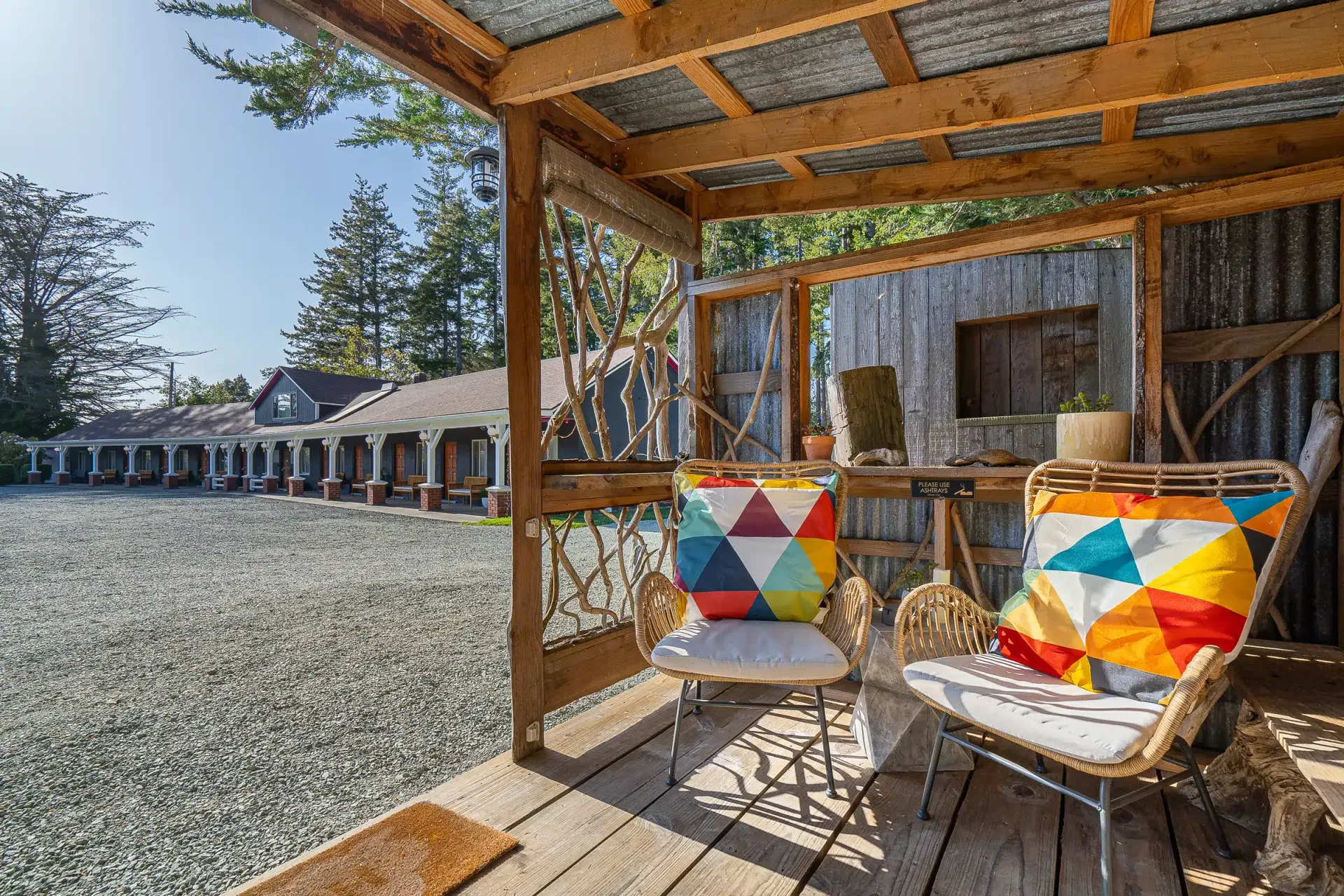 There are two chairs and a table on the porch.