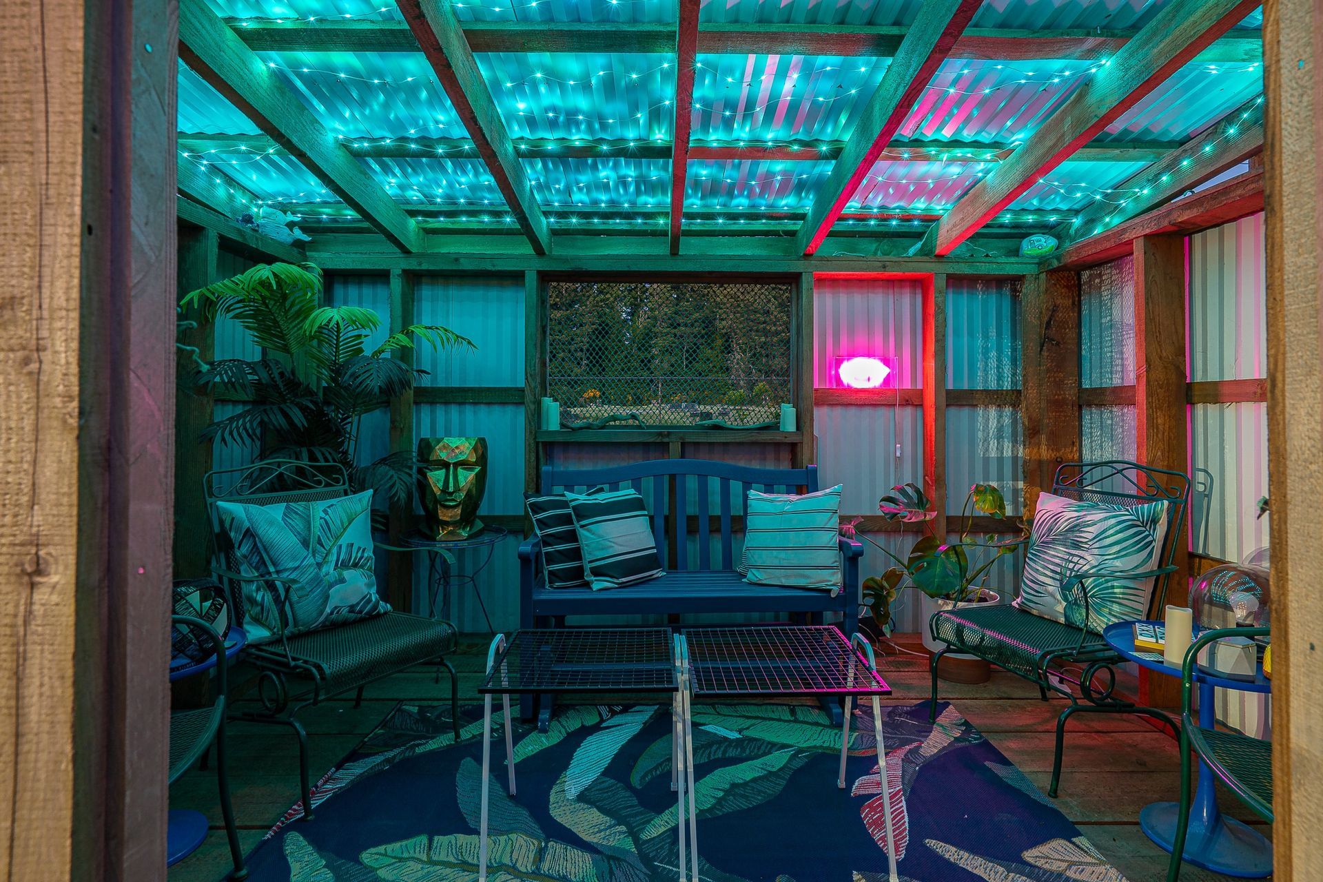 A living room with a fireplace , chair , rug and mirror.