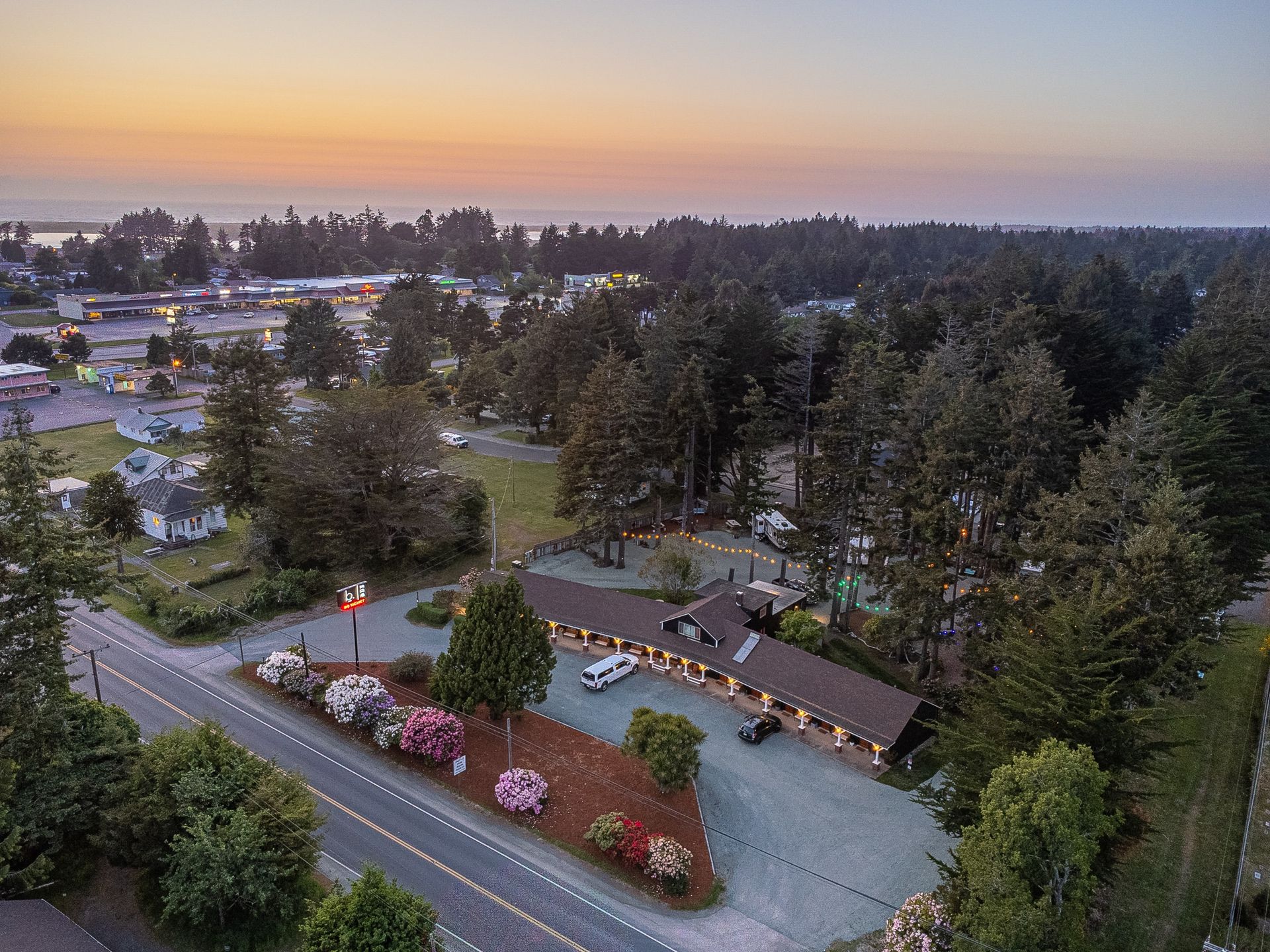 A chair with a blue pillow is sitting in a living room next to a wooden table.