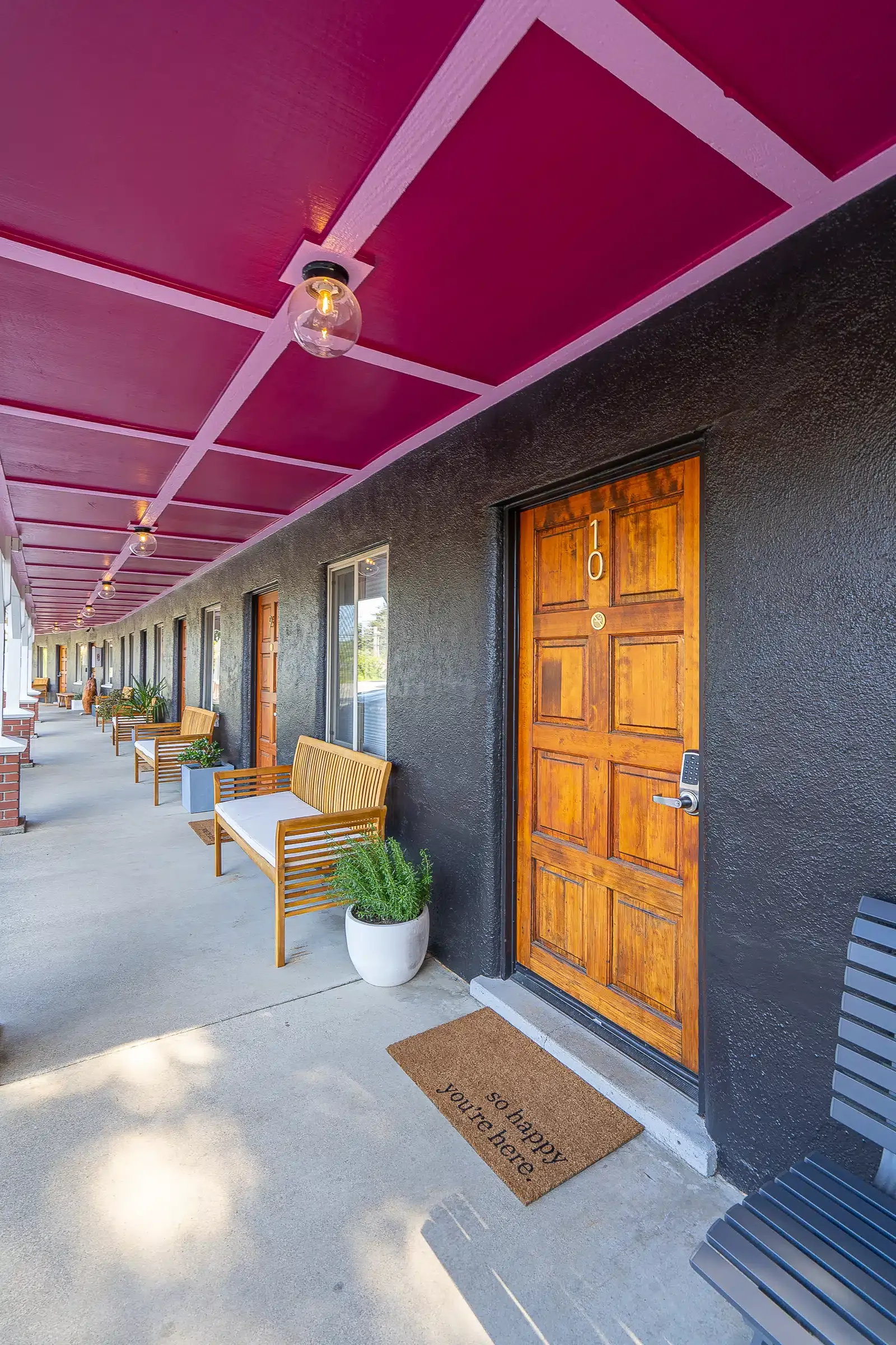 A hotel with a purple ceiling and a wooden door.