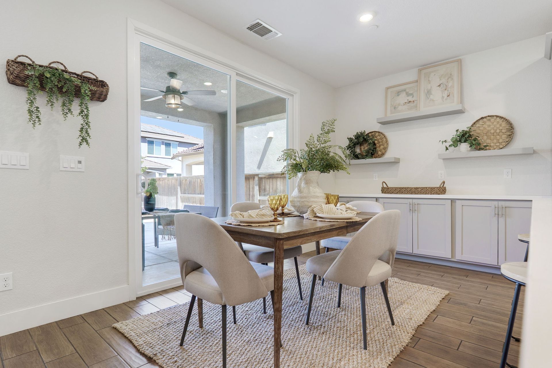 Dining room with table, chairs, decor, and sliding glass door to a patio.