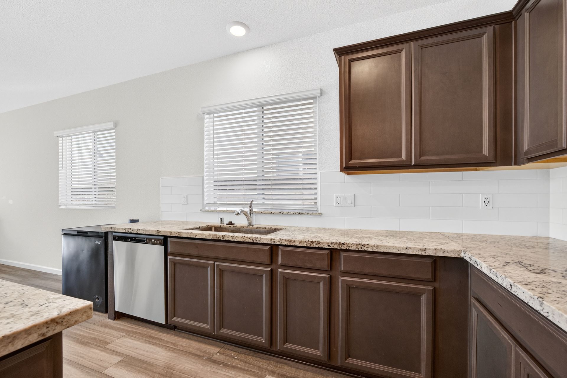 Kitchen with brown cabinets, granite countertops, and stainless steel appliances.