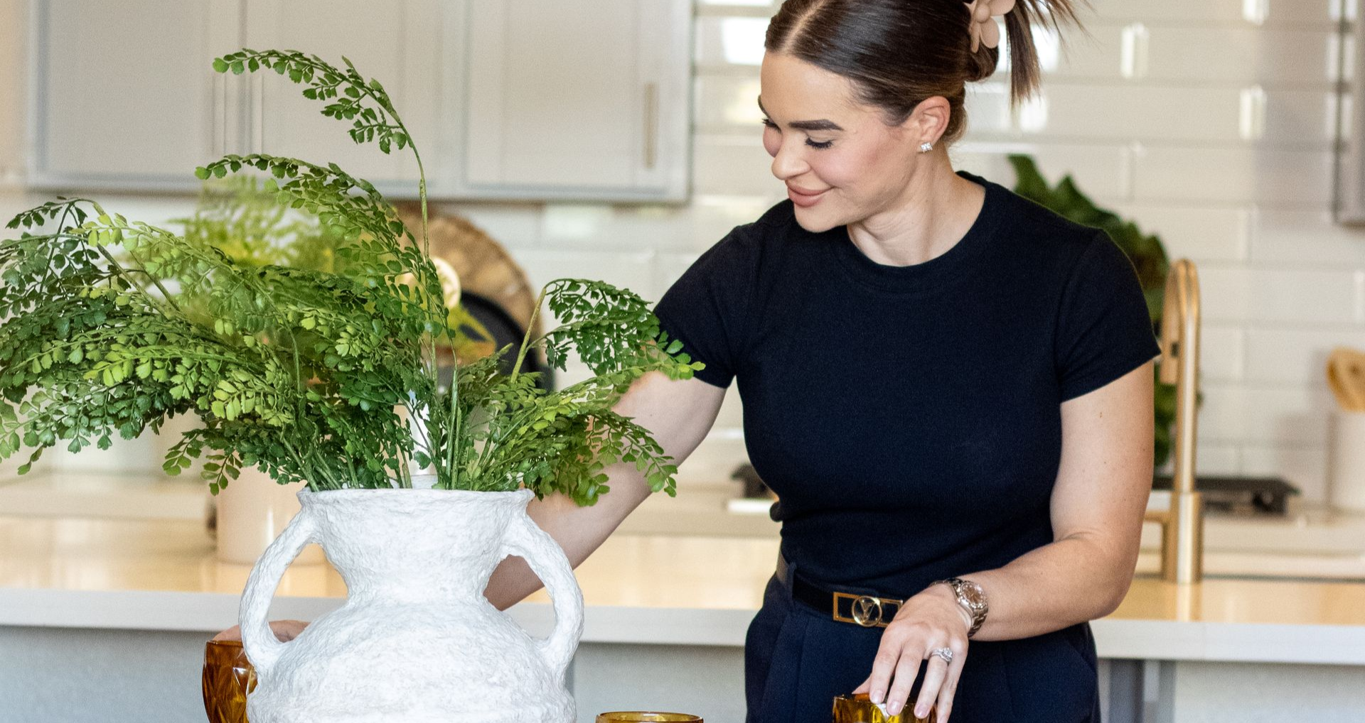 Business card and glasses on floral fabric.