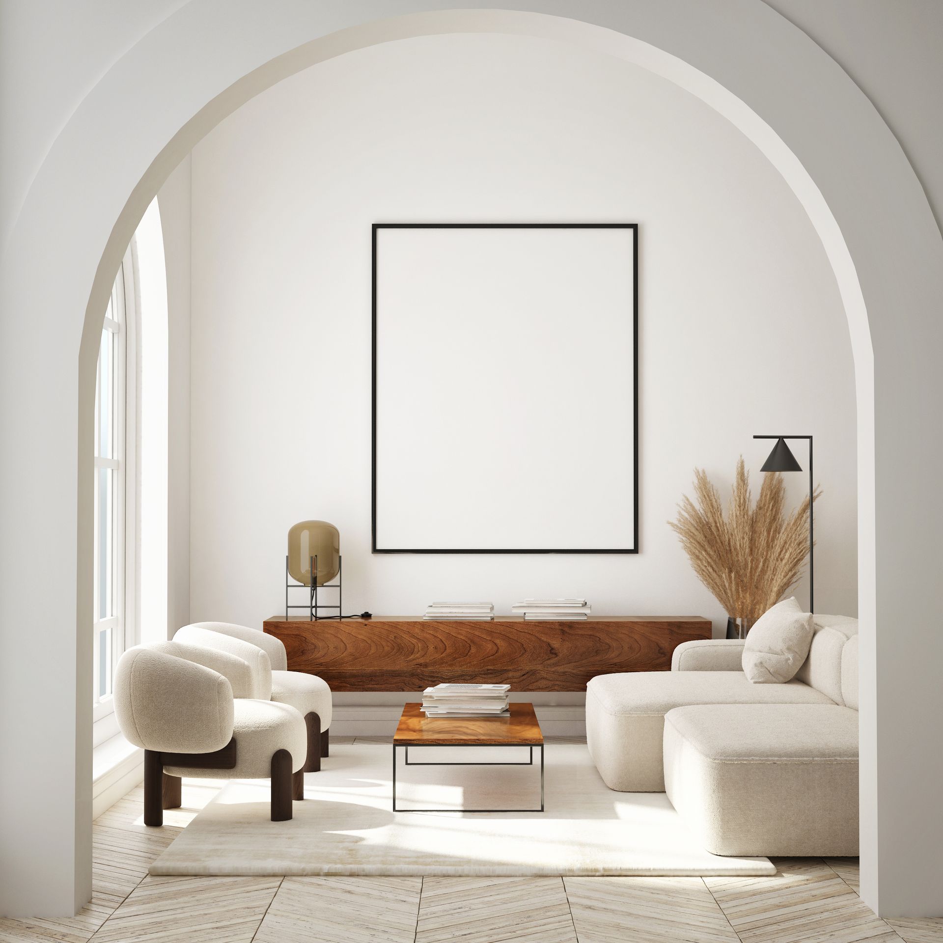 Living room with arched doorway, cream-colored sofa and chairs, wooden cabinet, and blank framed art.
