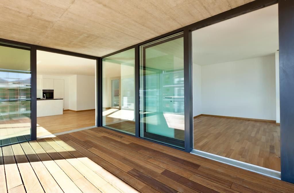 An Empty House With Sliding Glass Doors and a Wooden Deck — Glass & Window Centre, Dubbo, NSW