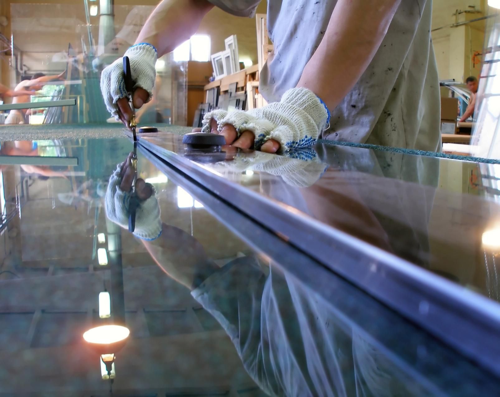 Person is Cutting a Piece of Glass With a Pair of Scissors — Glass & Window Centre, Dubbo, NSW
