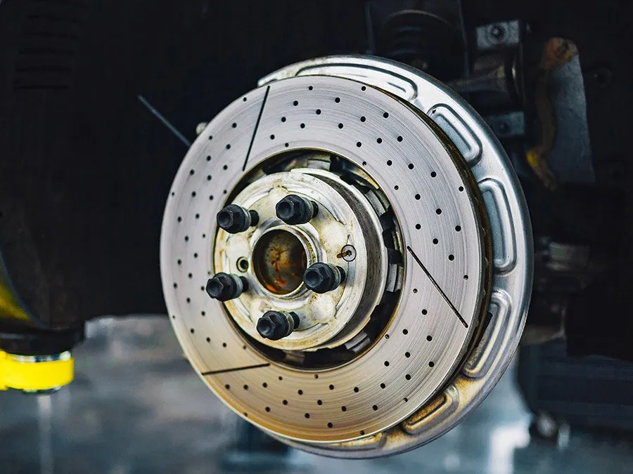 A close up of a brake disc on a car.