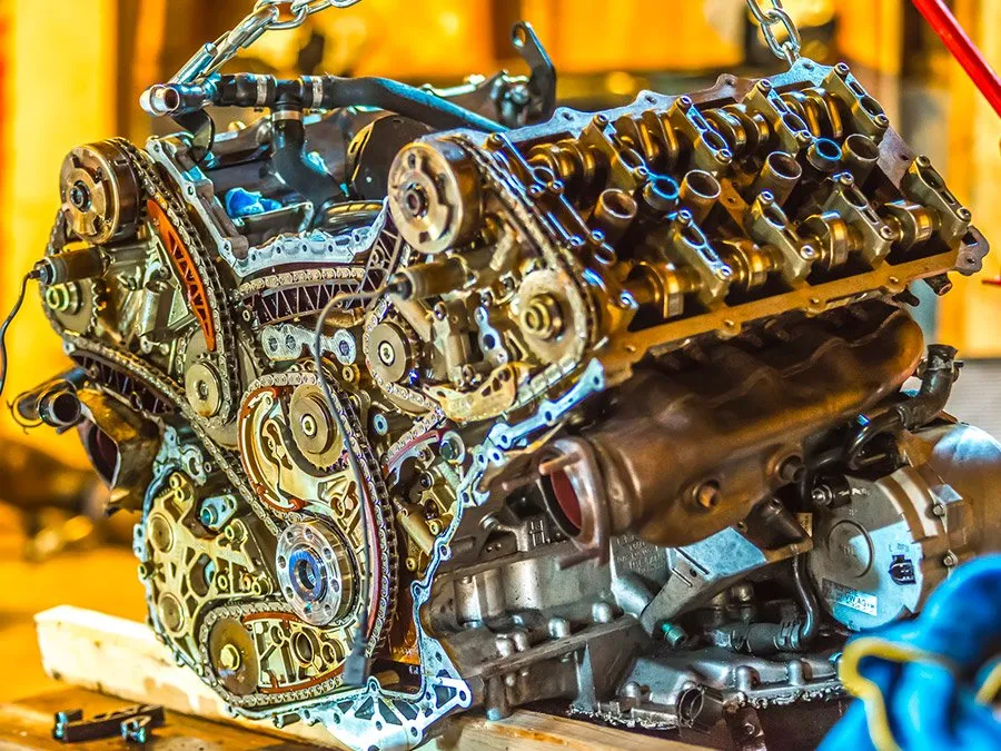 A close up of a car engine being worked on.