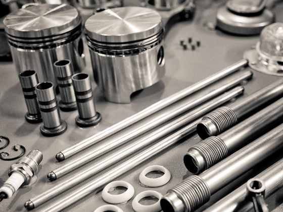 A black and white photo of a bunch of metal parts on a table.