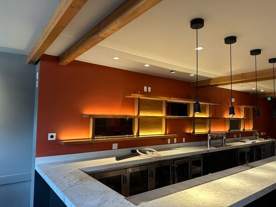 White ceiling air vent with a leafy green plant in the foreground.