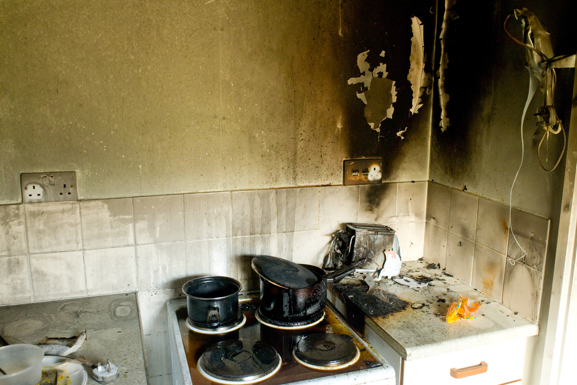 a kitchen with a stove that has been damaged by a fire