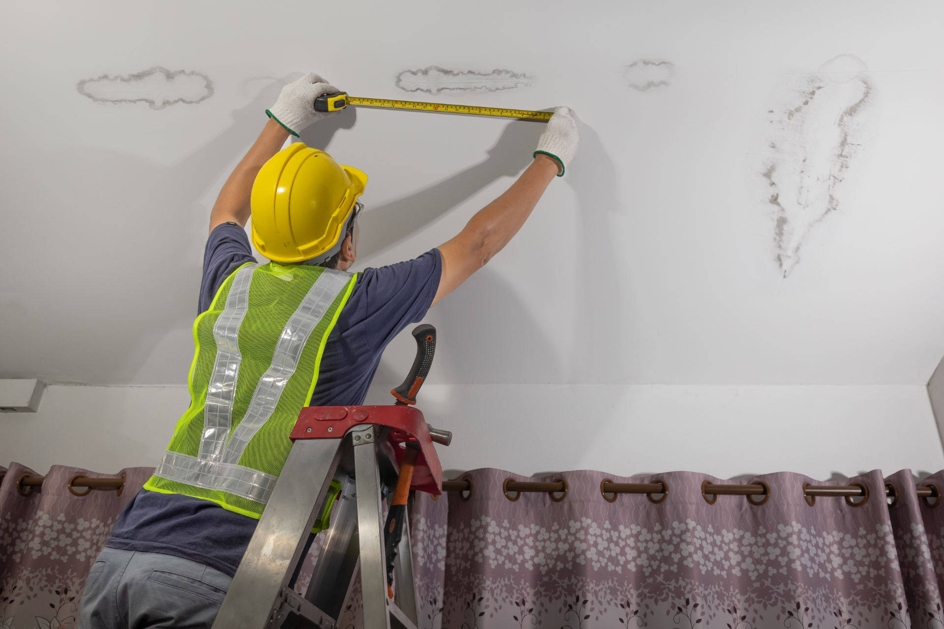 Worker Fixing Leaking Pipe on Ceiling 