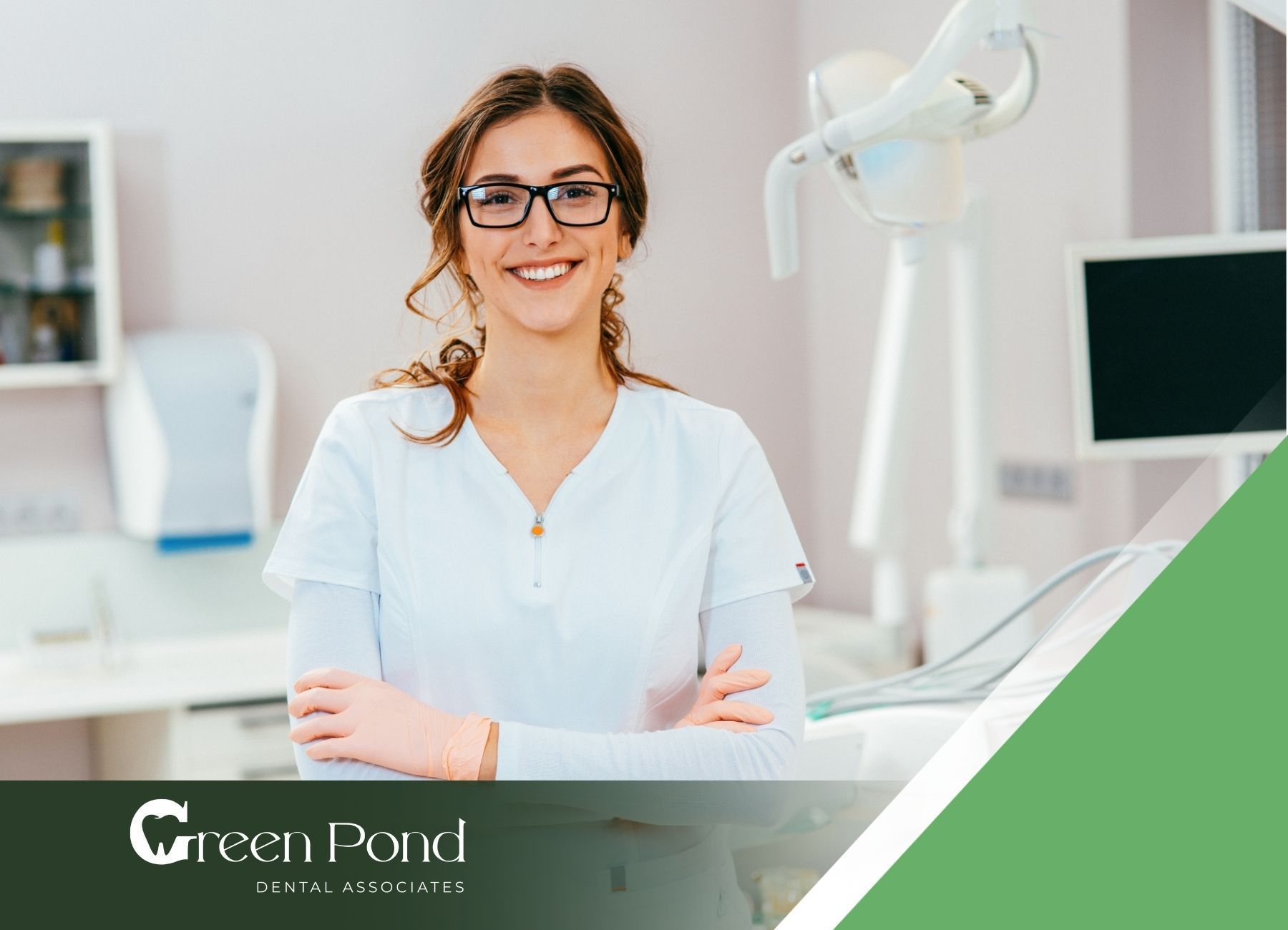 A female dentist is smiling in a dental office.