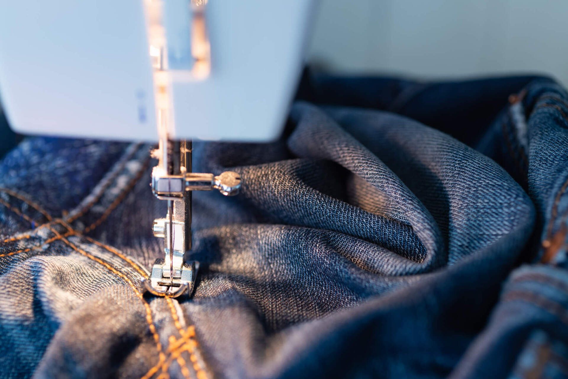 Repairing Jeans on the Sewing Machine — Valdosta, GA — Pleats & Creases Cleaners