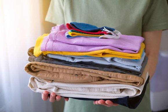 Clean Folded Cotton Jeans and Bright Colored T-shirts — Valdosta, GA — Pleats & Creases Cleaners