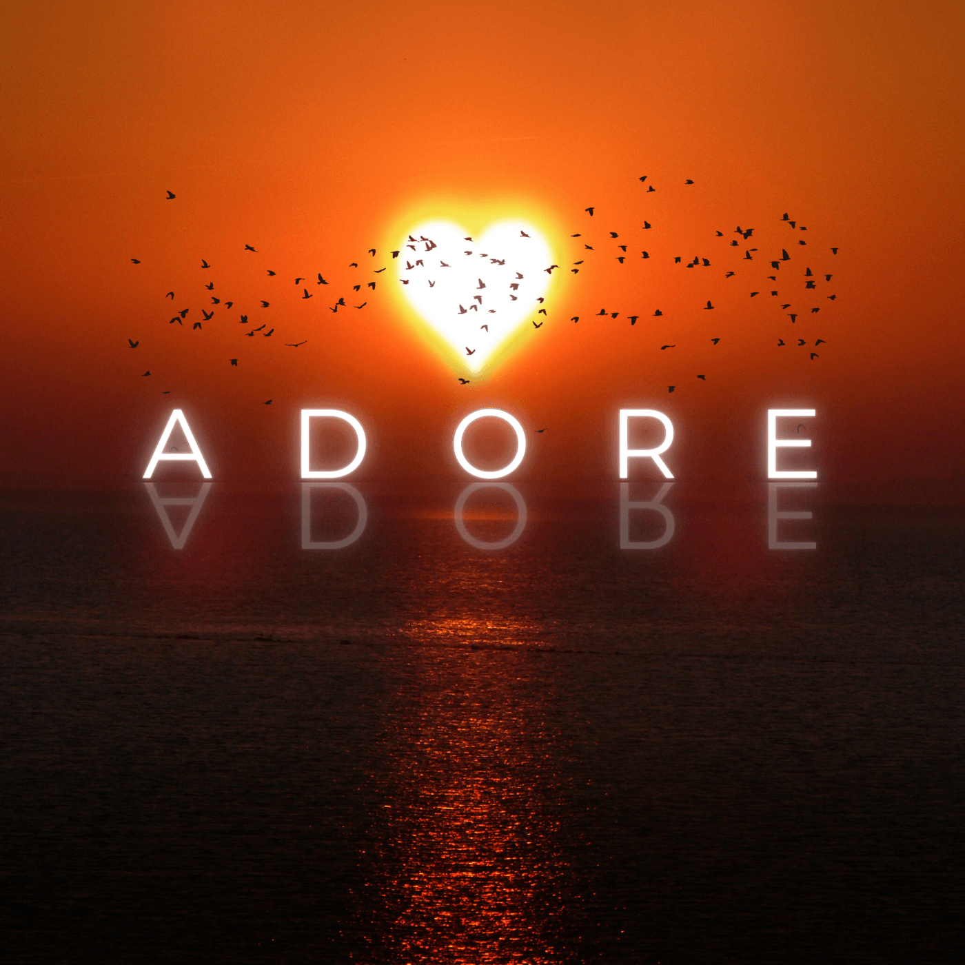 A sunset with a heart and the word adore